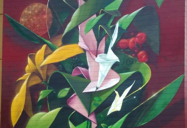 Detail of a big wall mural painting representing various colored flowers spherical Dandelion seedheads and green leaves. Artwork by Dado.