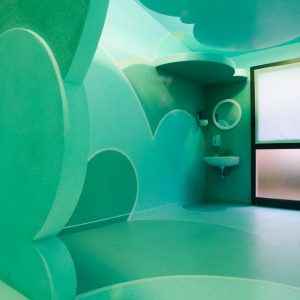 Total view of a relaxing room inside a s SPA decorated and painted all over with cloud-like bas relief in the tones of sky-blue and water green. Decoration by Dado.