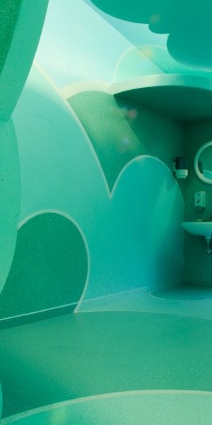 Total view of a relaxing room inside a s SPA decorated and painted all over with cloud-like bas relief in the tones of sky-blue and water green. Decoration by Dado.