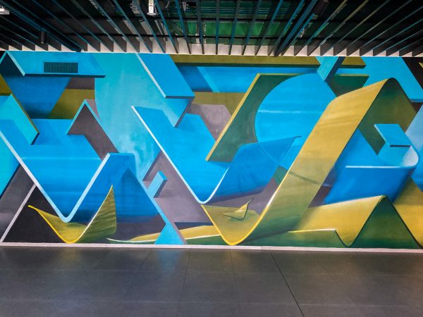 Detail of a wall decoration representing intersecting blue and green ribbons in a sophisticated geometrical pattern. Aerosol art by Dado.