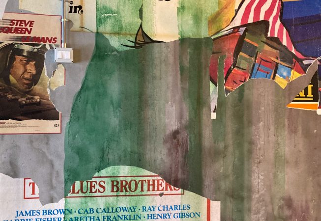 Detail of torn paper posters as a part of a decorated garage interior walls recreating a street underground atmosphere. Artwork by Dado.
