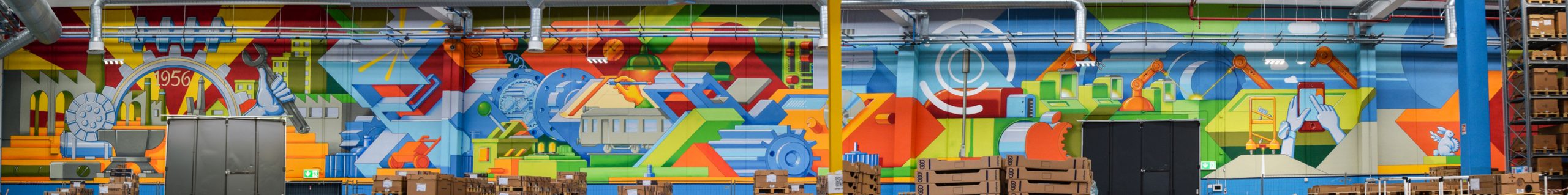 Dado-Wall-at-Bonfiglioli-EVO-Factory-Italy-total-panorama Total panoramic view of a big wall painting representing the historic evolution of the Binfiglioli Riduttori Company. Wall painting by Dado.