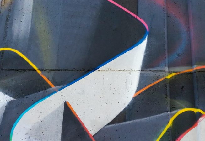 Mural painting representing weaving stiff ribbons forming the name of the artist Dado, in dark grays and white tones with sharp cutting multi color outline. Detail