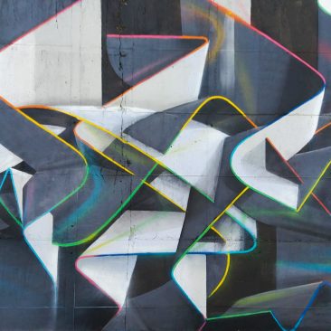 Mural painting representing weaving stiff ribbons forming the name of the artist Dado, in dark grays and white tones with sharp cutting multi color outline. Core detail