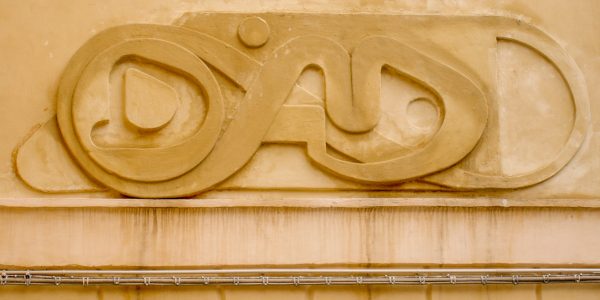 Bas-relief sculpture in a contemporary graffiti lettering fixed on a above a Medieval vault architecture well pairing. Front view detail. Artwork by Dado