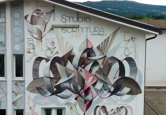 Closer detail of a mural painting depicting the graphic studies for any single letter forming the name Dado in a graffiti wildstyle piece, front aereal view