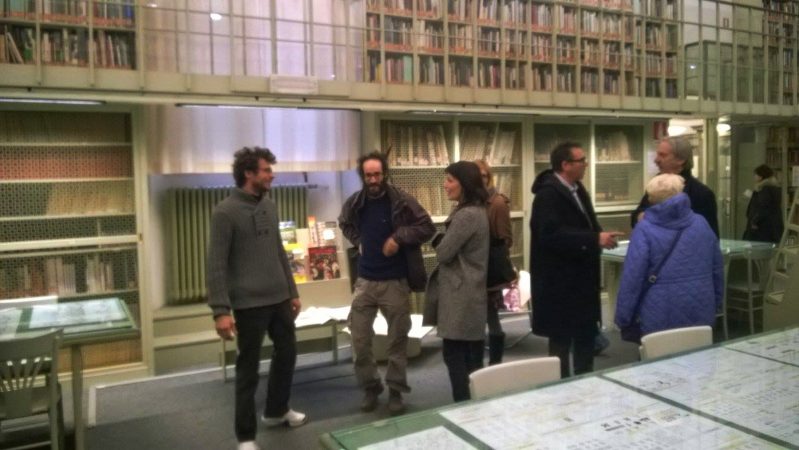 Dado Ferri inside an art gallery talking with visitors