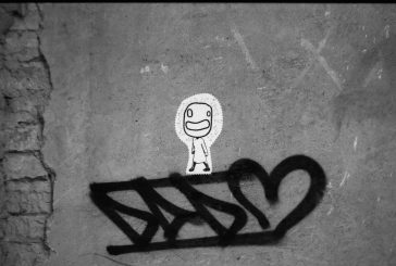 Dado spray can tag on cement wall with white paper sticker by Cuoghi Corsello on top