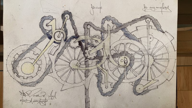 Black pen graffiti sketch on white paper depicting the tag Dado in a mechanical style with letters resembling gear cogs pulling a chain