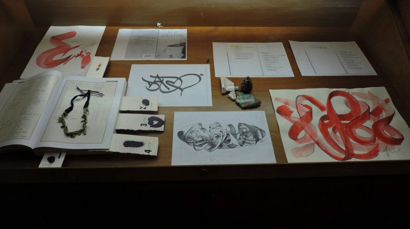 A museum showcase displaying various drawings and sketches by Dado Ferri