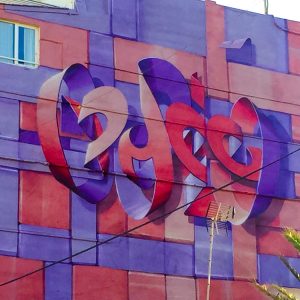 Bottom view of a Mural painting on an high building face depicting floating bent ribbons creating two names altogether the tag Dado and the name Eva in a pale red and electric blue tones